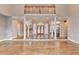 Elegant living space with hardwood floors, classic columns, and access to other areas of the home at 3871 River Mansion Dr, Peachtree Corners, GA 30096