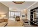 Bright living room with bay window seating, a fireplace, and elegant chandelier at 3871 River Mansion Dr, Peachtree Corners, GA 30096