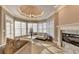 Charming living room with a fireplace, bay windows, and a stylish chandelier at 3871 River Mansion Dr, Peachtree Corners, GA 30096