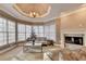 Bright living room featuring large windows, a fireplace, and decorative lighting at 3871 River Mansion Dr, Peachtree Corners, GA 30096