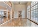 Sunlit living room featuring hardwood floors, soaring ceilings, and access to outdoor living space at 3871 River Mansion Dr, Peachtree Corners, GA 30096