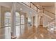 Bright living room with tall columns, fireplace, hardwood floors, and large windows at 3871 River Mansion Dr, Peachtree Corners, GA 30096