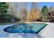 A large in-ground pool is surrounded by trees and landscaping to create a private backyard space at 3871 River Mansion Dr, Peachtree Corners, GA 30096