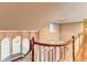 Upper staircase and landing with decorative windows and curved wood banister at 3871 River Mansion Dr, Peachtree Corners, GA 30096