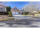 View of a charming two-story home with a brick facade, a long driveway, and well-maintained landscaping at 500 Sapphire Valley Ln, Canton, GA 30114