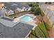 Aerial view showcasing a community pool surrounded by manicured landscaping and residential buildings at 938 Burnt Hickory Nw Cir, Marietta, GA 30064