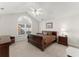 Bright bedroom featuring large window, neutral carpet, and a ceiling fan at 938 Burnt Hickory Nw Cir, Marietta, GA 30064