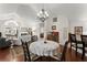 Open dining area featuring hardwood floors, chandelier, and open access to the living room at 938 Burnt Hickory Nw Cir, Marietta, GA 30064