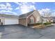 A well-maintained home featuring a two-car garage, an American flag, and manicured front yard at 938 Burnt Hickory Nw Cir, Marietta, GA 30064