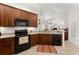 View of the kitchen area, showcasing dark cabinetry, appliances, and lots of natural light at 938 Burnt Hickory Nw Cir, Marietta, GA 30064