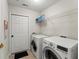 A functional laundry room featuring a modern washer and dryer set and convenient overhead shelving at 938 Burnt Hickory Nw Cir, Marietta, GA 30064