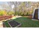 A spacious backyard features a stone fire pit with wooden planter boxes and exterior stairs to a deck at 152 Park Dr, Decatur, GA 30030