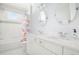 Bright bathroom featuring double sinks, a subway-tiled shower/tub, and a round mirror at 152 Park Dr, Decatur, GA 30030