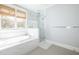 Serene bathroom with a soaking tub, a glass-enclosed shower and a large window with natural light at 152 Park Dr, Decatur, GA 30030