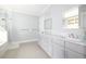 Bathroom featuring a marble-top double vanity, walk-in shower, and soft gray walls at 152 Park Dr, Decatur, GA 30030