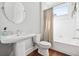 White bathroom features tile flooring, a large mirror, and a walk-in shower with curtain at 152 Park Dr, Decatur, GA 30030