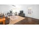 Cozy living room with hardwood floors, area rug, a tan sofa, desk area, and patio entrance at 152 Park Dr, Decatur, GA 30030