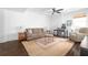 Cozy living room with hardwood floors, area rug, a tan sofa, and a desk area at 152 Park Dr, Decatur, GA 30030