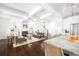 Open-concept living room adjacent to kitchen with hardwood floors and coffered ceilings at 152 Park Dr, Decatur, GA 30030
