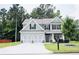 Charming two-story home with a well-manicured lawn and a spacious driveway leading to a two-car garage at 200 Stone Lake Dr, Dallas, GA 30157