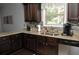 The kitchen has wood cabinets, granite counters, stainless appliances, and a tile backsplash at 200 Stone Lake Dr, Dallas, GA 30157