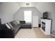 Attic living room featuring a fireplace, tv, and a large couch at 200 Stone Lake Dr, Dallas, GA 30157