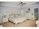 Spacious main bedroom with a decorative headboard, ceiling fan, and en-suite bathroom at 200 Stone Lake Dr, Dallas, GA 30157