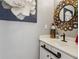 Charming powder room featuring a decorative mirror and elegant fixtures at 4212 Lazy Creek Dr, Marietta, GA 30066