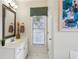 Well-lit bathroom featuring a white vanity, mirror, and decoratively framed window at 4212 Lazy Creek Dr, Marietta, GA 30066
