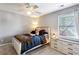 Cozy bedroom with a ceiling fan, a large window and stylish dresser at 4212 Lazy Creek Dr, Marietta, GA 30066
