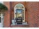 Close-up of an arched entryway with a black front door and decorative details at 4212 Lazy Creek Dr, Marietta, GA 30066