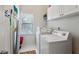 Functional laundry room with washer, dryer, and overhead cabinets at 4212 Lazy Creek Dr, Marietta, GA 30066