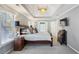 Spacious main bedroom suite with tray ceiling, chandelier and large windows at 4212 Lazy Creek Dr, Marietta, GA 30066
