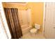 Bathroom featuring a shower with a patterned curtain, a white toilet, and white floors at 6610 Sunbriar Dr, Cumming, GA 30040