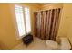 Bathroom with a window with shutters, patterned shower curtain, toilet and cabinet at 6610 Sunbriar Dr, Cumming, GA 30040