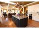 Spacious kitchen with an island, copper pot rack, and an open layout flowing into the living room at 6610 Sunbriar Dr, Cumming, GA 30040