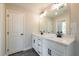 Bathroom featuring double vanity, black hardware, a large mirror, and modern lighting at 163 Bluffington Way, Marietta, GA 30066