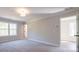 Spacious bedroom with neutral walls, carpet flooring, and natural light from the window at 163 Bluffington Way, Marietta, GA 30066