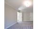 Large bedroom with neutral walls, carpet flooring, and two white doors at 163 Bluffington Way, Marietta, GA 30066