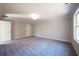 Open bedroom with carpeted floors, neutral walls, and two white doors at 163 Bluffington Way, Marietta, GA 30066
