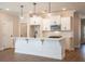 Bright, eat-in kitchen with white cabinetry, stainless appliances, and a large center island at 163 Bluffington Way, Marietta, GA 30066