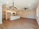 Open-concept living room with white walls, recessed lighting, wood floors, and an elegant chandelier at 163 Bluffington Way, Marietta, GA 30066