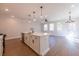 Bright and spacious living room showcases wood floors, a kitchen island and recessed lighting at 163 Bluffington Way, Marietta, GA 30066