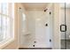 Modern glass enclosed shower with white subway tile and matte black hardware at 163 Bluffington Way, Marietta, GA 30066