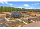 New construction home with a green roof, tennis courts, a covered pavilion, and landscaping on a sunny day at 188 Balsam Dr, Dallas, GA 30157