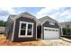 Charming home showcasing stylish gray siding, crisp white trim, and an attached two-car garage at 188 Balsam Dr, Dallas, GA 30157