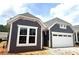 Charming home showcasing stylish gray siding, crisp white trim, and an attached two-car garage at 188 Balsam Dr, Dallas, GA 30157
