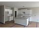 Bright, unfinished kitchen features white cabinets, granite countertops and a central island at 188 Balsam Dr, Dallas, GA 30157