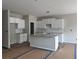 Bright, unfinished kitchen features white cabinets, granite countertops and a central island at 188 Balsam Dr, Dallas, GA 30157