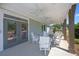 Covered outdoor patio furnished with white chairs and tables for relaxation and entertaining guests at 188 Balsam Dr, Dallas, GA 30157